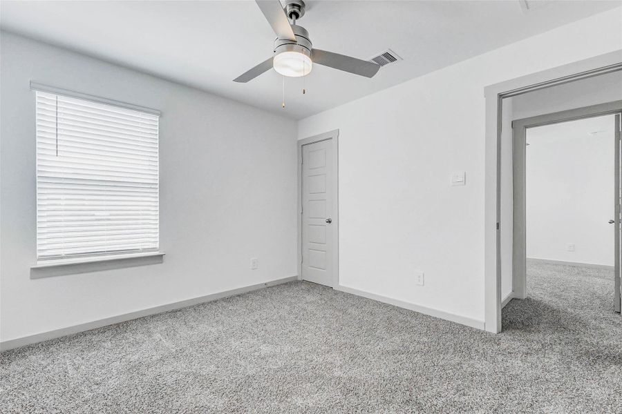Natural light fills this cozy bedroom, complete with soft carpeting, sleek ceiling fan, and access to a private closet. Clean lines and bright walls make it easy to envision the space personalized to your lifestyle. Natural light fills this cozy bedroom, complete with soft carpeting, sleek ceiling fan, and access to a private closet. Clean lines and bright walls make it easy to envision the space personalized to your lifestyle.