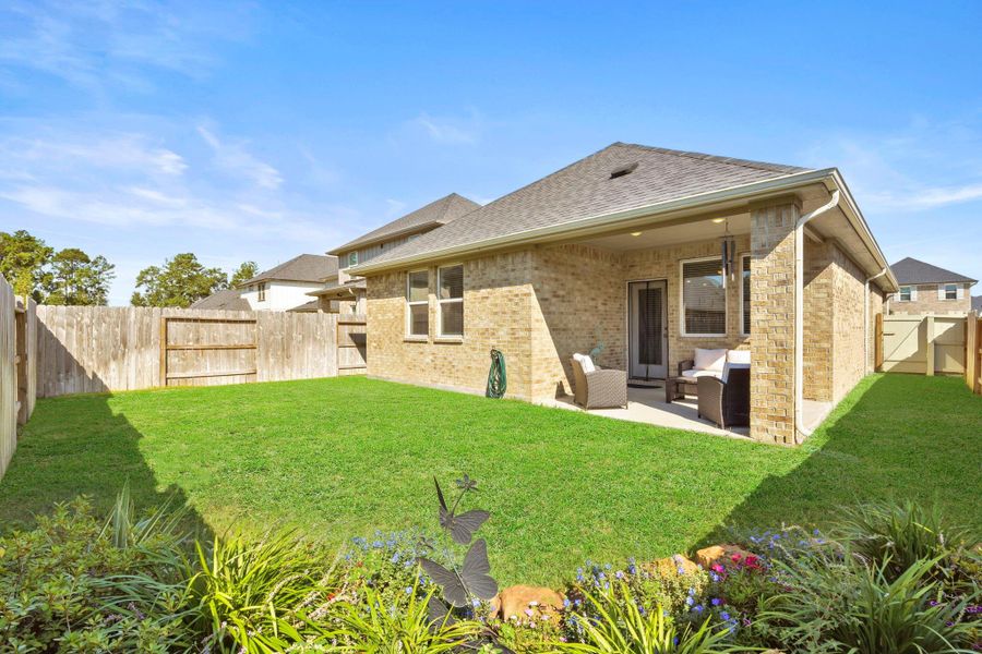 Exterior details and patio area of a home in Harper's Preserve - Traditional Series, Conroe (Image 21).