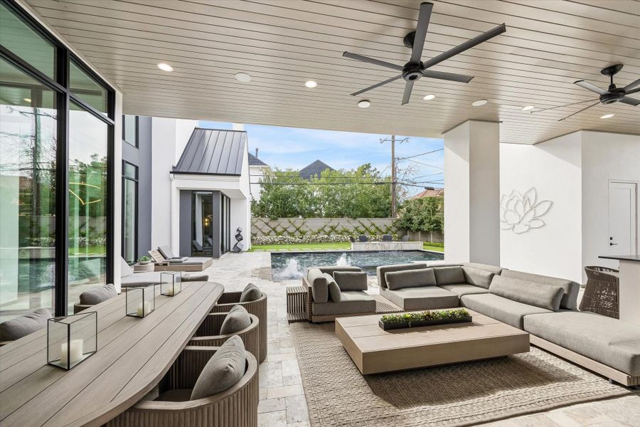 Outdoor dining and living space with a custom LED art piece hanging on the wall that looks incredible at night. The backyard also has uprights for the meticulous modern landscaping. Outdoor dining and living space with a custom LED art piece hanging on the wall that looks incredible at night. The backyard also has uprights for the meticulous modern landscaping.