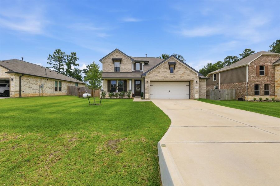 Front exterior of a new home in Deer Trail Estates, Conroe, TX, highlighting curb appeal (Image 24).