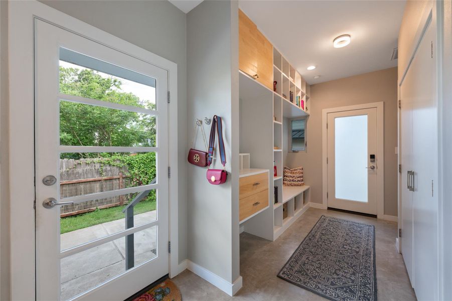 Bright entry area with ample built-in storage solutions and direct backyard access. Bright entry area with ample built-in storage solutions and direct backyard access.