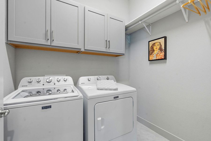 Laundry area featuring washing machine and dryer and cabinet space Laundry area featuring washing machine and dryer and cabinet space