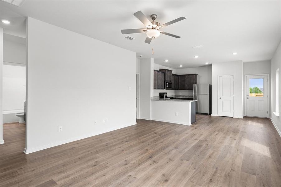 Unfurnished living room with recessed lighting, light wood-type flooring, and a ceiling fan Unfurnished living room with recessed lighting, light wood-type flooring, and a ceiling fan