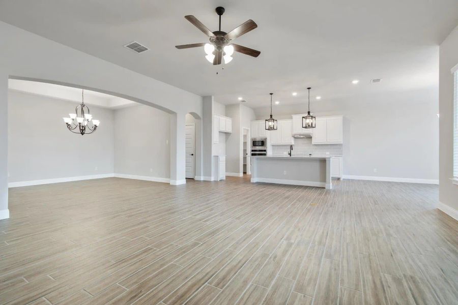Family Room to Kitchen | Concept 2373 at Coyote Crossing in Godley, TX by Landsea Homes Family Room to Kitchen | Concept 2373 at Coyote Crossing in Godley, TX by Landsea Homes