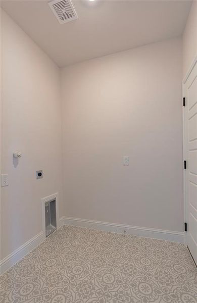 Washroom featuring hookup for an electric dryer