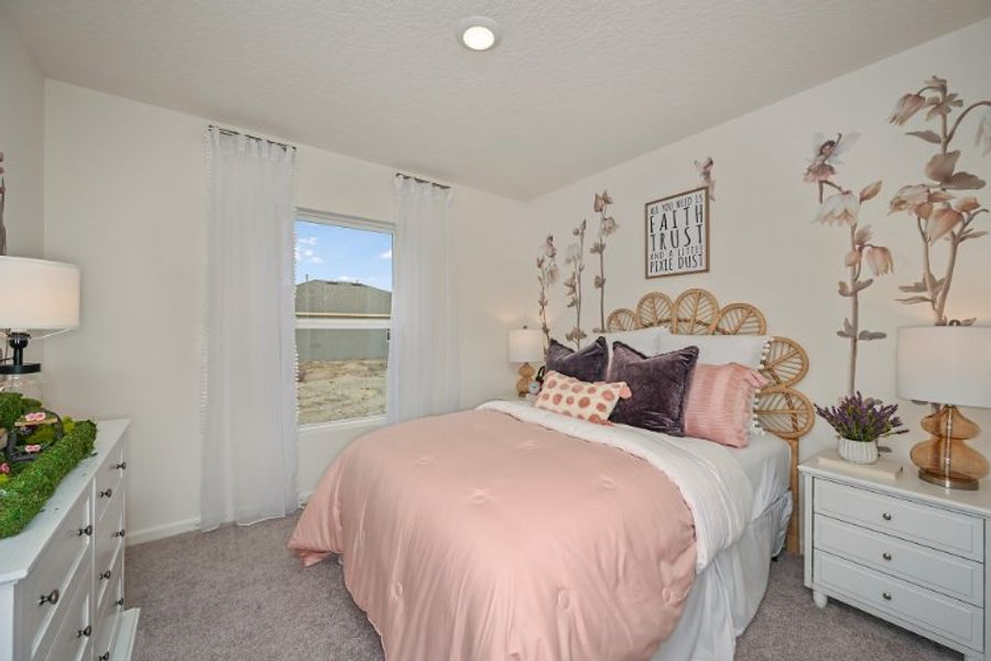 A bedroom with a bed and a window.