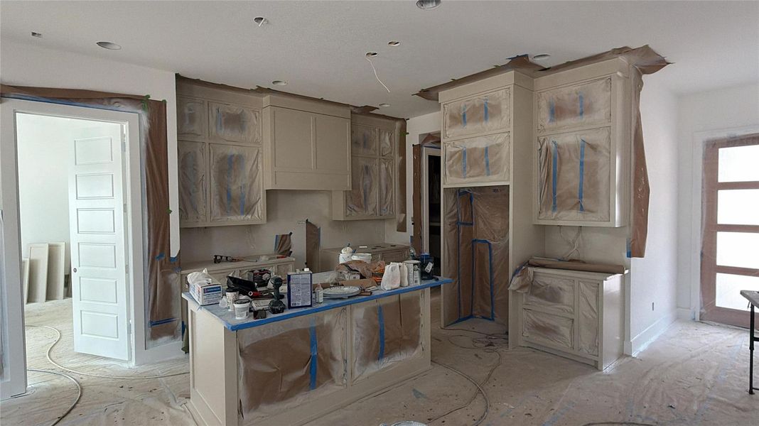 Actual view of the planned kitchen layout showcasing the generous workspace, custom cabinetry, and seamless flow into the main living area.