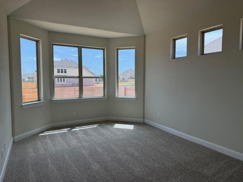Spare room with carpet, healthy amount of natural light, and vaulted ceiling Spare room with carpet, healthy amount of natural light, and vaulted ceiling