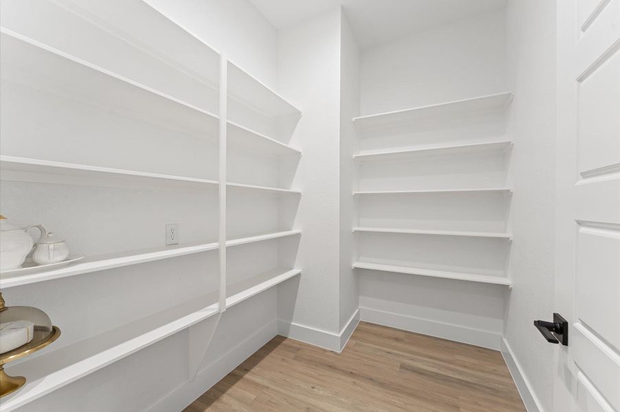 Generous walk-in pantry provides ample storage space with built-in shelves. Generous walk-in pantry provides ample storage space with built-in shelves.