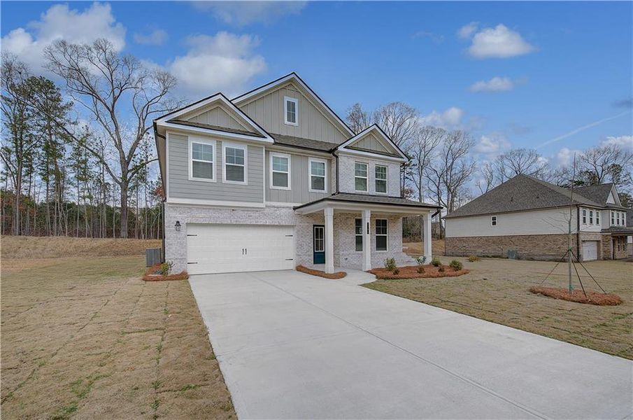 Front exterior of a new home in Hamilton Lakes, Lawrenceville, GA, highlighting curb appeal (Image 17).