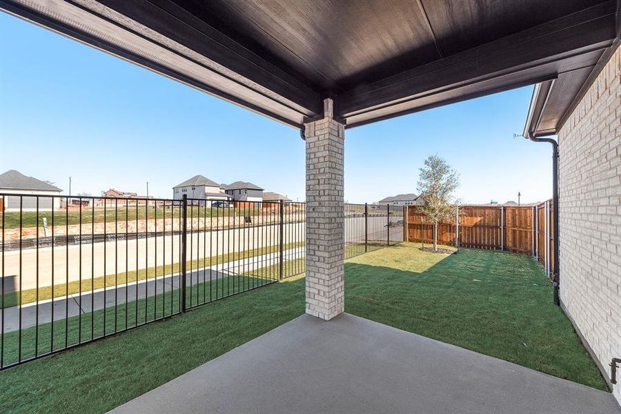 Fenced backyard with a patio area Fenced backyard with a patio area