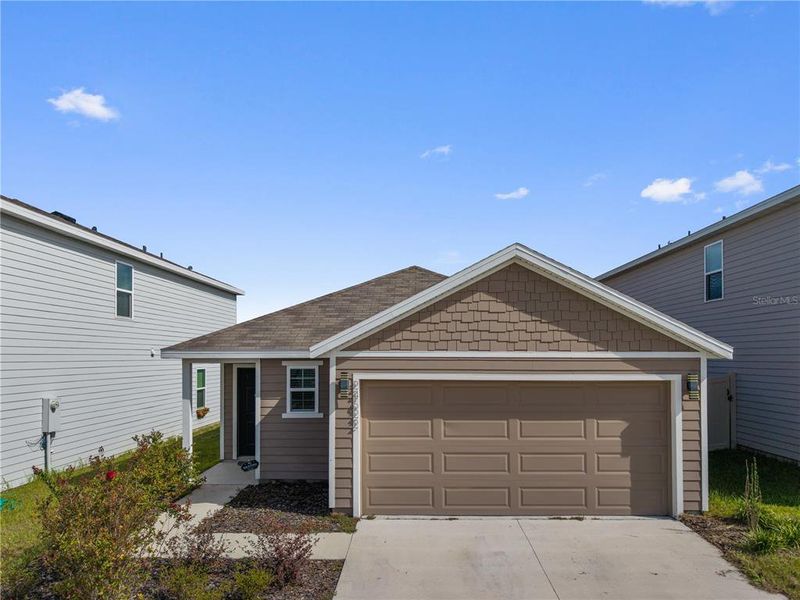 Front exterior of a new home in Avalon Woods, Newberry, FL, highlighting curb appeal (Image 25).