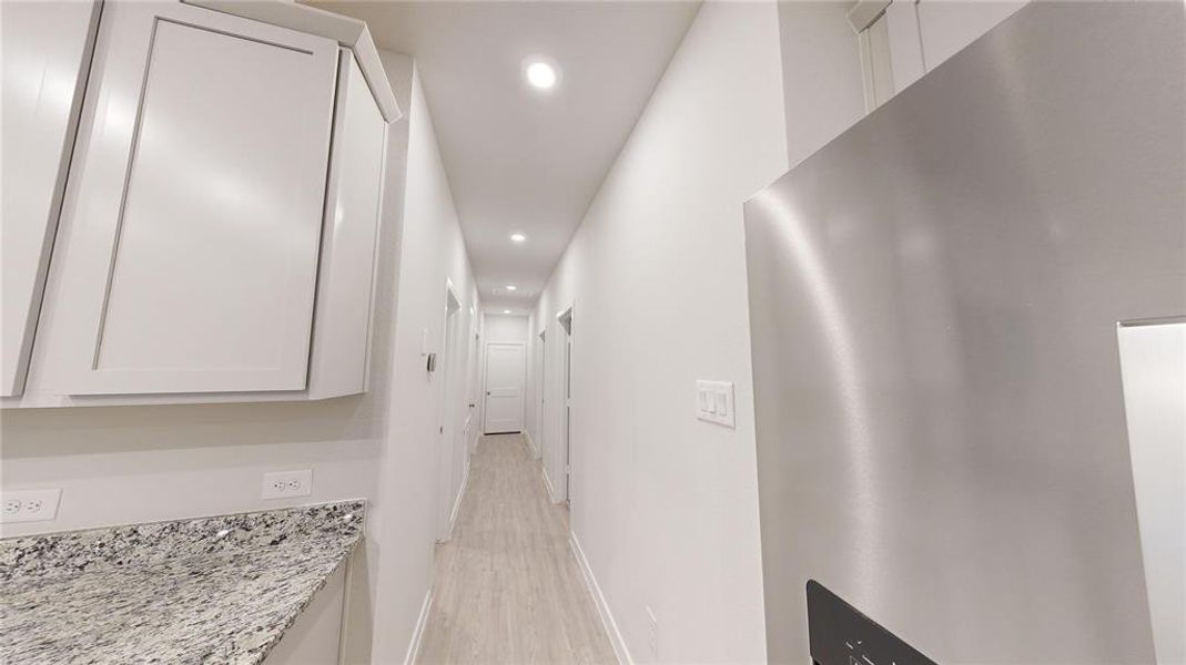 Hallway from Kitchen to the secondary bedrooms and to the garage.