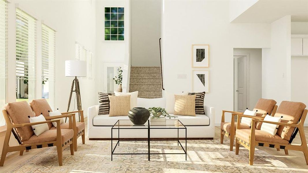 Sitting room featuring light hardwood / wood-style flooring and a towering ceiling