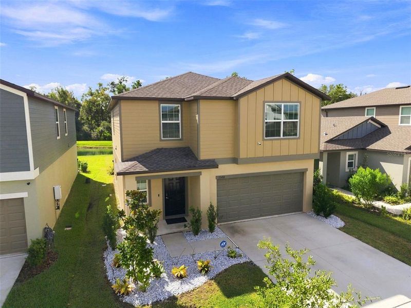 Front exterior of a new home in Two Rivers, Zephyrhills, FL, highlighting curb appeal (Image 24). Front exterior of a new home in Two Rivers, Zephyrhills, FL, highlighting curb appeal (Image 24).
