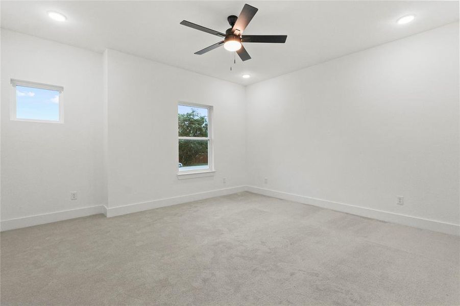 Unfurnished room with light carpet, recessed lighting, and ceiling fan Unfurnished room with light carpet, recessed lighting, and ceiling fan