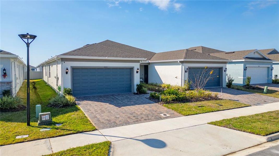Front exterior of a new home in , Kissimmee, FL, highlighting curb appeal (Image 24).