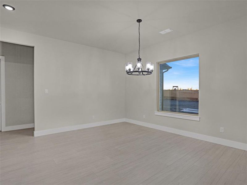 Empty room featuring an inviting chandelier