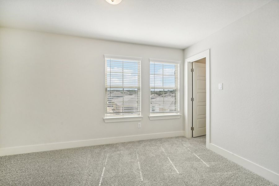 Guest bedroom in the Medina floorplan at a Meritage Homes community.