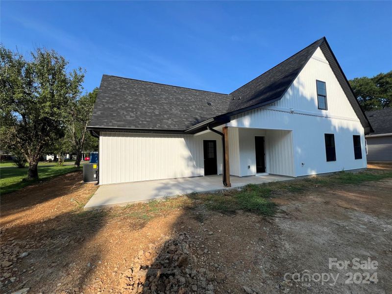 Rear view with covered porch and patio area