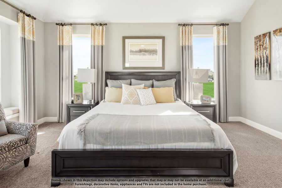 Bedroom with dark wood bed frame, neutral carpet, two windows, and matching nightstands with lamps