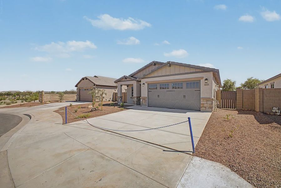 Front exterior of a new home in Avanti at Granite Vista, Waddell, AZ, highlighting curb appeal (Image 22).