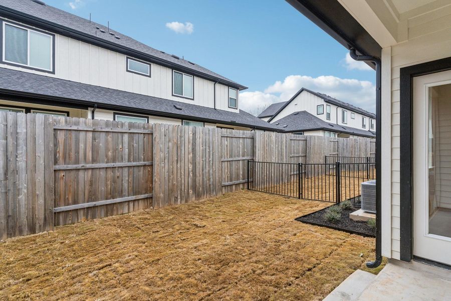 Exterior details and patio area of a home in Townhomes at Gattis, Round Rock (Image 3).