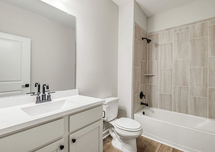 The secondary bathroom features beautiful shower details