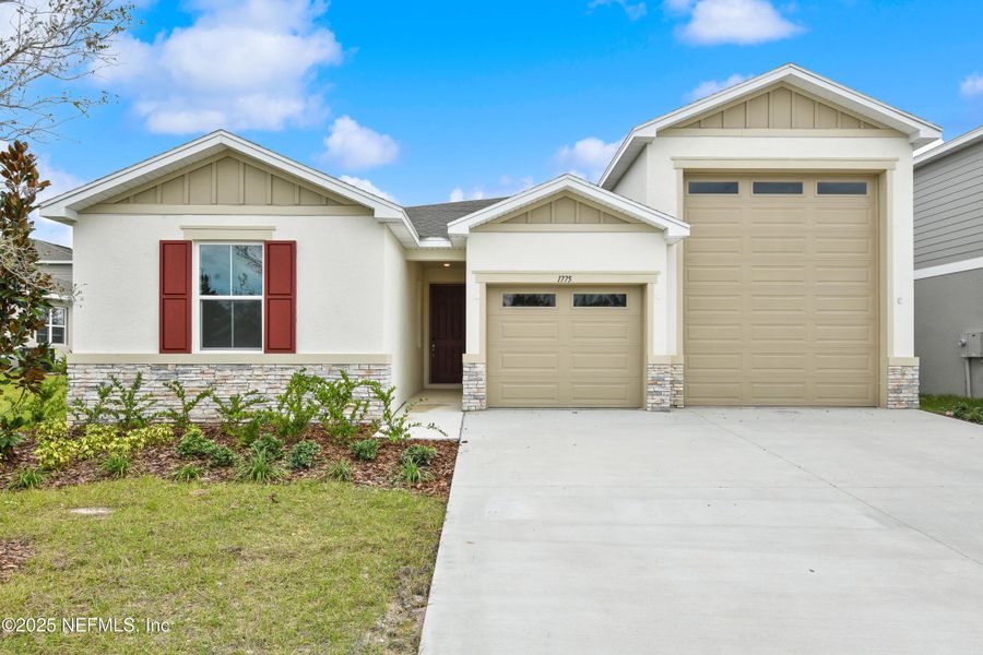 Front exterior of a new home in Seasons at Grandview Gardens, Deland, FL, highlighting curb appeal (Image 2).