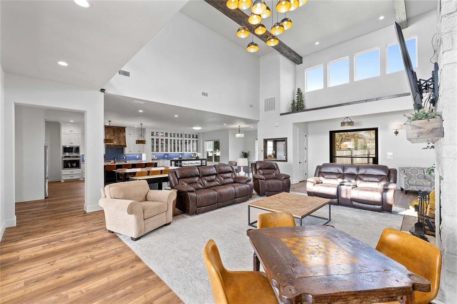 Living area featuring a chandelier, light wood-style flooring, and recessed lighting