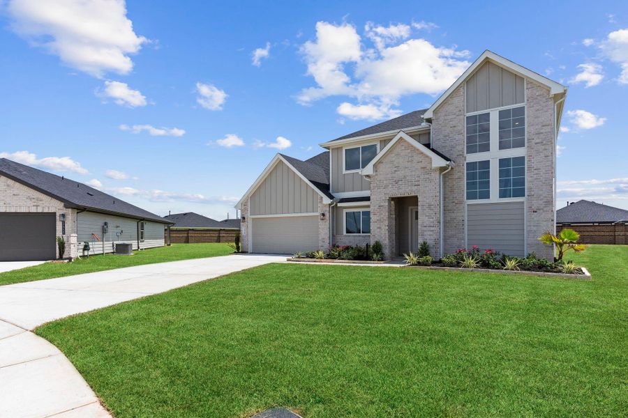 Front exterior of a new home in Tamarron, Fulshear, TX, highlighting curb appeal (Image 1). Front exterior of a new home in Tamarron, Fulshear, TX, highlighting curb appeal (Image 1).