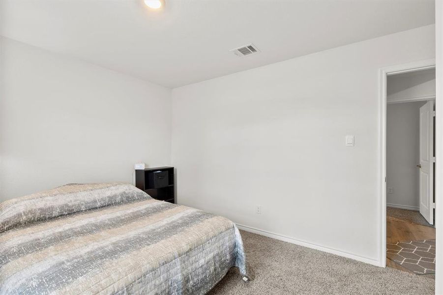 Carpeted bedroom with baseboards
