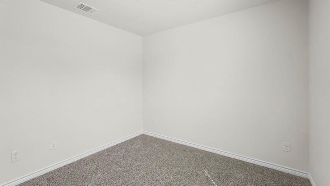 The room features light-colored walls, gray carpet, and white baseboards