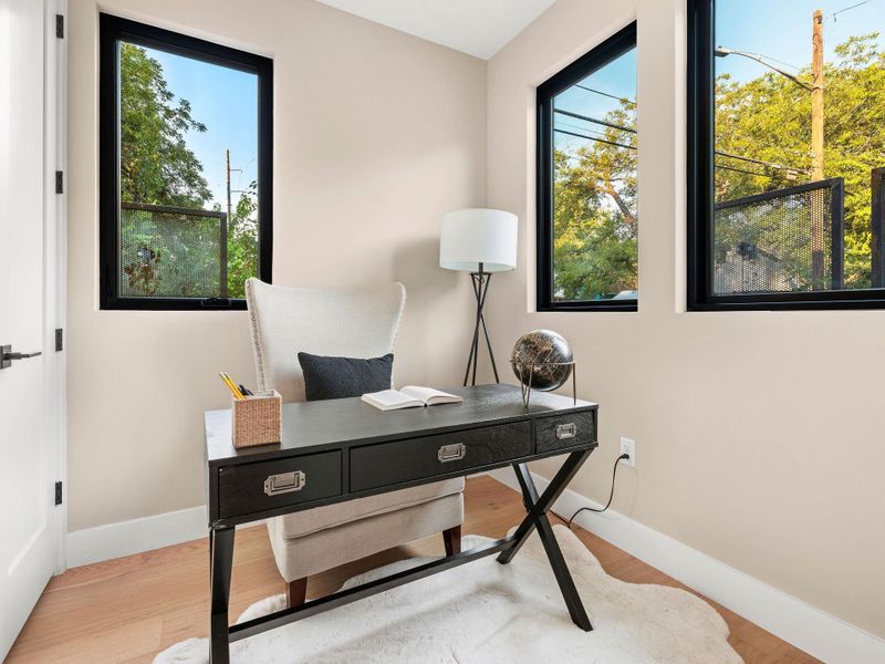 Office space featuring wood finished floors and baseboards Office space featuring wood finished floors and baseboards