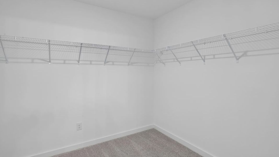 Spacious walk-in closet for primary suite Spacious walk-in closet for primary suite