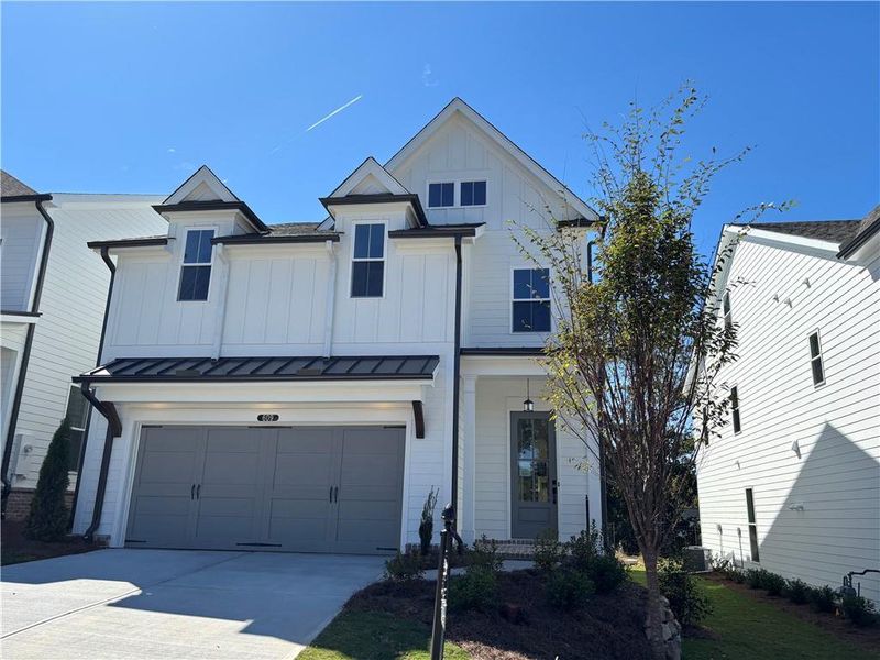 Front exterior of a new home in Palisades Single Family, Cumming, GA, highlighting curb appeal (Image 1).