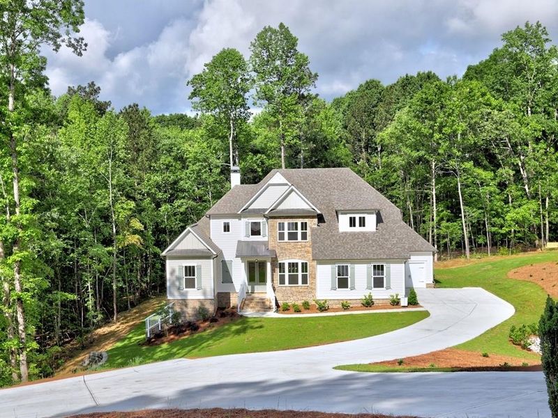 Front exterior of a new home in Chattahoochee Reserve, Cumming, GA, highlighting curb appeal (Image 13). Front exterior of a new home in Chattahoochee Reserve, Cumming, GA, highlighting curb appeal (Image 13).