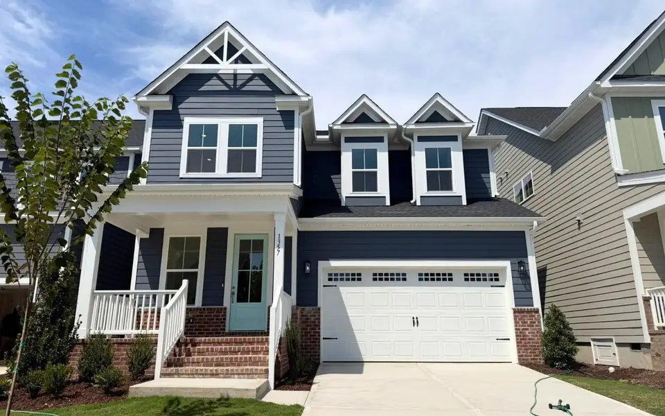 Front exterior of a new home in Wendell Falls, Wendell, NC, highlighting curb appeal (Image 1). Front exterior of a new home in Wendell Falls, Wendell, NC, highlighting curb appeal (Image 1).