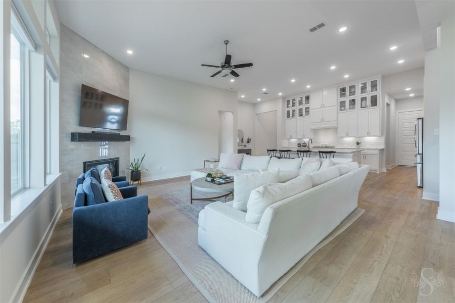 This inviting view highlights the impressive size of the family room and its connection to the stunning kitchen. Gorgeous flooring carries throughout the open living spaces for a cohesive designer look. This inviting view highlights the impressive size of the family room and its connection to the stunning kitchen. Gorgeous flooring carries throughout the open living spaces for a cohesive designer look.