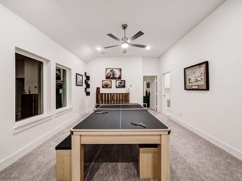 Playroom featuring light colored carpet, vaulted ceiling, a ceiling fan, and recessed lighting Playroom featuring light colored carpet, vaulted ceiling, a ceiling fan, and recessed lighting