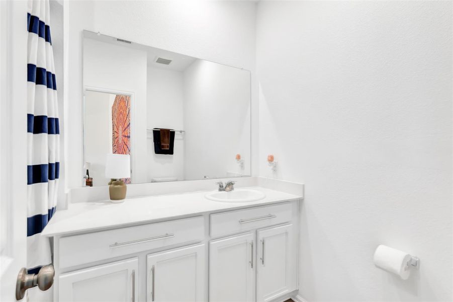 Primary bath with single sink and ample storage.