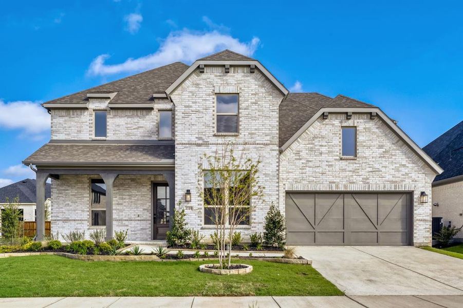 French country style house featuring covered porch, roof with shingles, a front yard, brick siding, and concrete driveway French country style house featuring covered porch, roof with shingles, a front yard, brick siding, and concrete driveway