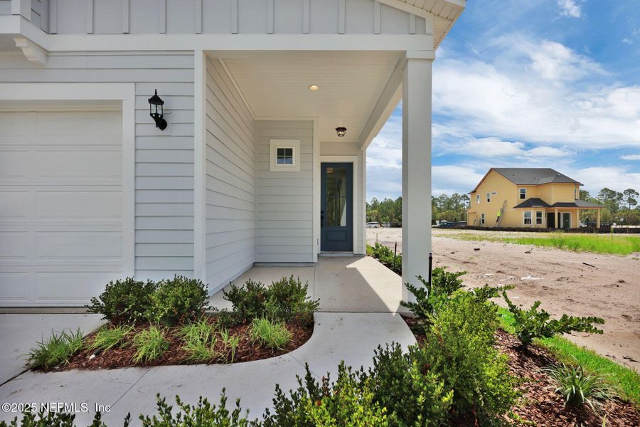 Front exterior of a new home in Seabrook Village at Nocatee, Ponte Vedra, FL, highlighting curb appeal (Image 2). Front exterior of a new home in Seabrook Village at Nocatee, Ponte Vedra, FL, highlighting curb appeal (Image 2).