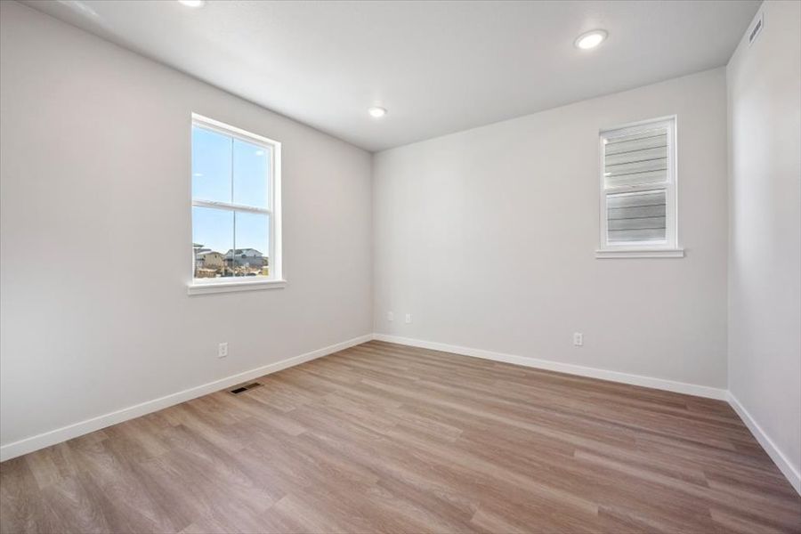 A room with a wood floor and a window with a wood floor. A room with a wood floor and a window with a wood floor.