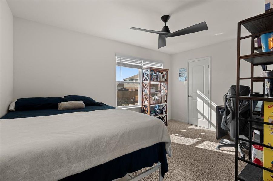 Bedroom with light carpet and ceiling fan