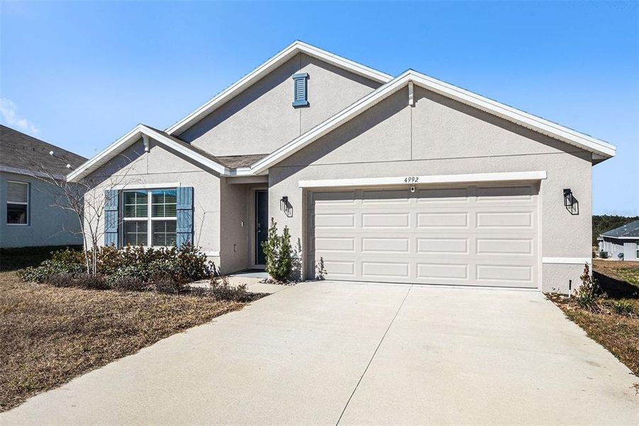Front exterior of a new home in Fairways at Twisted Oaks, Beverly Hills, FL, highlighting curb appeal (Image 23).