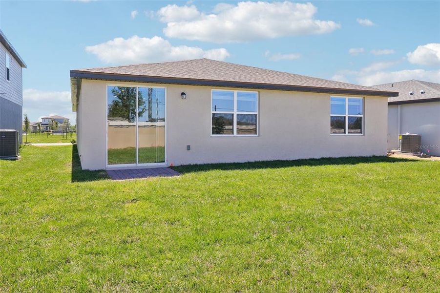 Front exterior of a new home in Lawson Dunes - Signature Series, Haines City, FL, highlighting curb appeal (Image 18). Front exterior of a new home in Lawson Dunes - Signature Series, Haines City, FL, highlighting curb appeal (Image 18).