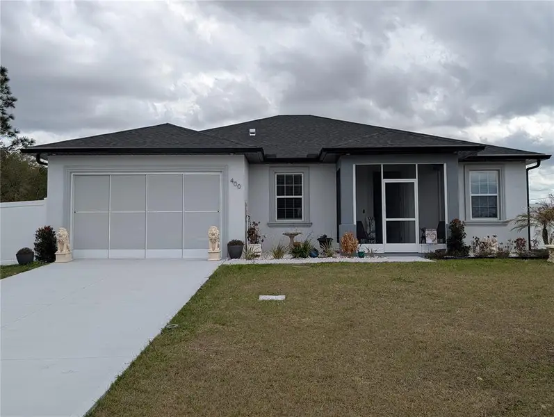 Front exterior of a new home in , Poinciana, FL, highlighting curb appeal (Image 2).