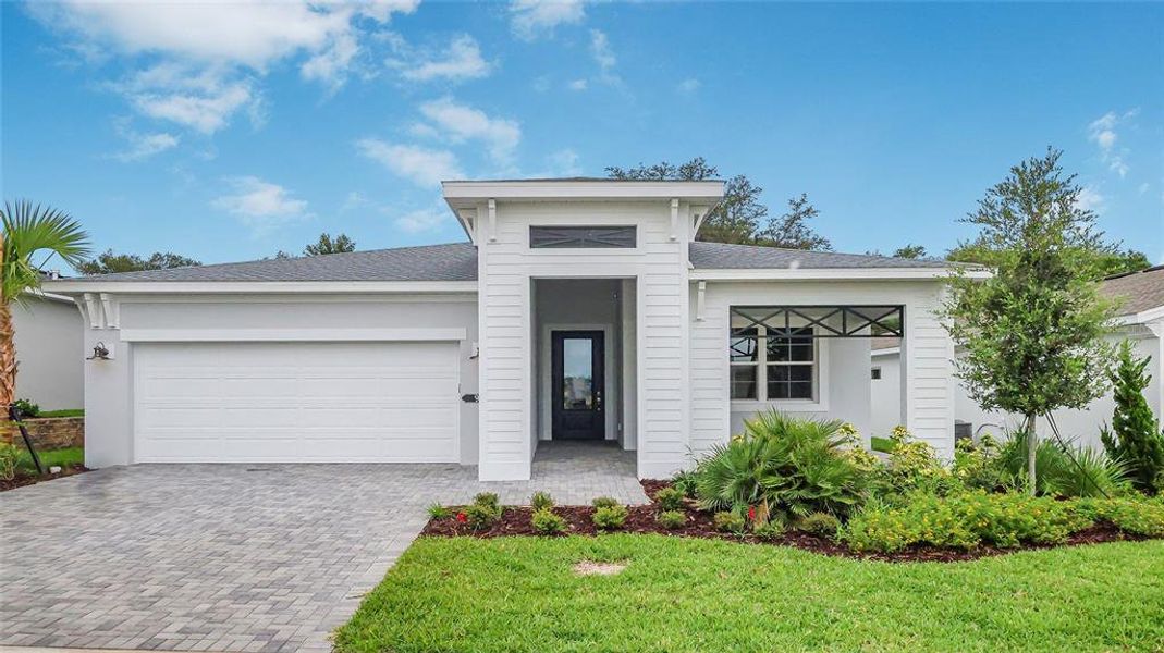 Front exterior of a new home in Cresswind at Hammock Oaks, Lady Lake, FL, highlighting curb appeal (Image 2). Front exterior of a new home in Cresswind at Hammock Oaks, Lady Lake, FL, highlighting curb appeal (Image 2).