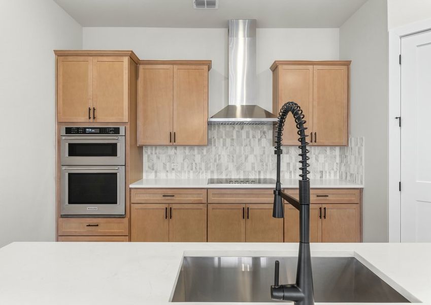 The kitchen has sprawling quartz countertops.